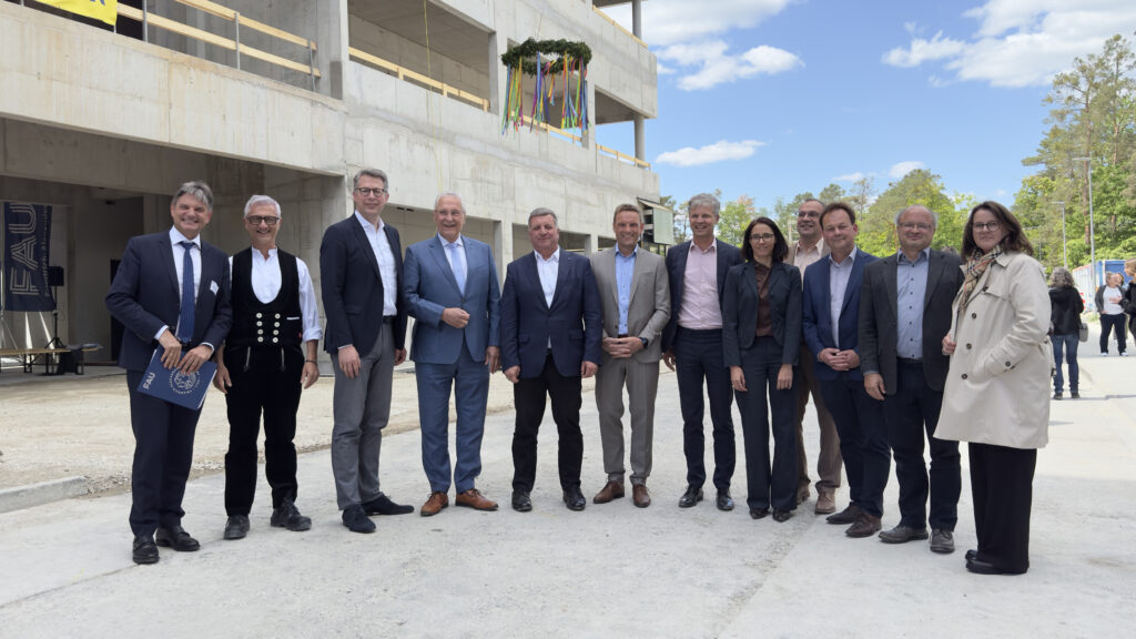 Richtfest für die Technische Chemie der FAU: (3.v.l.) Bayerns Wissenschaftsminister Markus Blume, (4.v.l.) Bayerns Innenminister Joachim Herrmann, (5.v.l.) Bayerns Bauminister Christian Bernreiter und Prof. Joachim Hornegger, Präsident der FAU (links) zusammen mit Vertreterinnen und Vertretern des staatlichen Bauamts, der FAU sowie der Stadt und beteiligter Firmen. (© Axel König/StMWK)